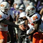 Oct 30 2010 Manhattan KS USA Oklahoma State Cowboys quarterback Brandon Weeden 3 hands off to running back Kendall Hunter 24 in the first half against the Kansas State Wildcats at Bill Snyder Family Stadium. Mandatory Credit John Rieger US PRESSWIRE