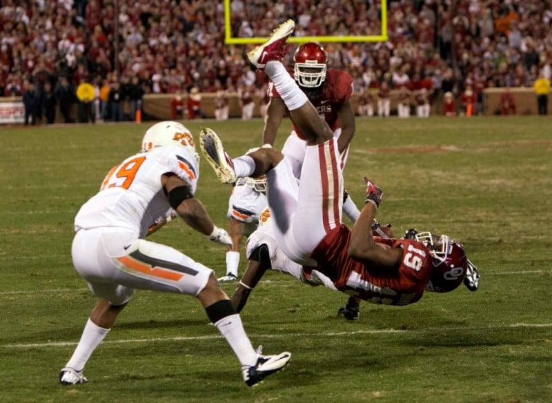 Nov 24 2012 Norman OK USA Oklahoma Sooners wide receiver Justin Brown 19 is tackled by Oklahoma State Cowboys safety Daytawion Lowe 8 during the fourth quarter at Oklahoma Memorial Stadium. Mandatory Credit Richard Rowe US PRESSWIRE