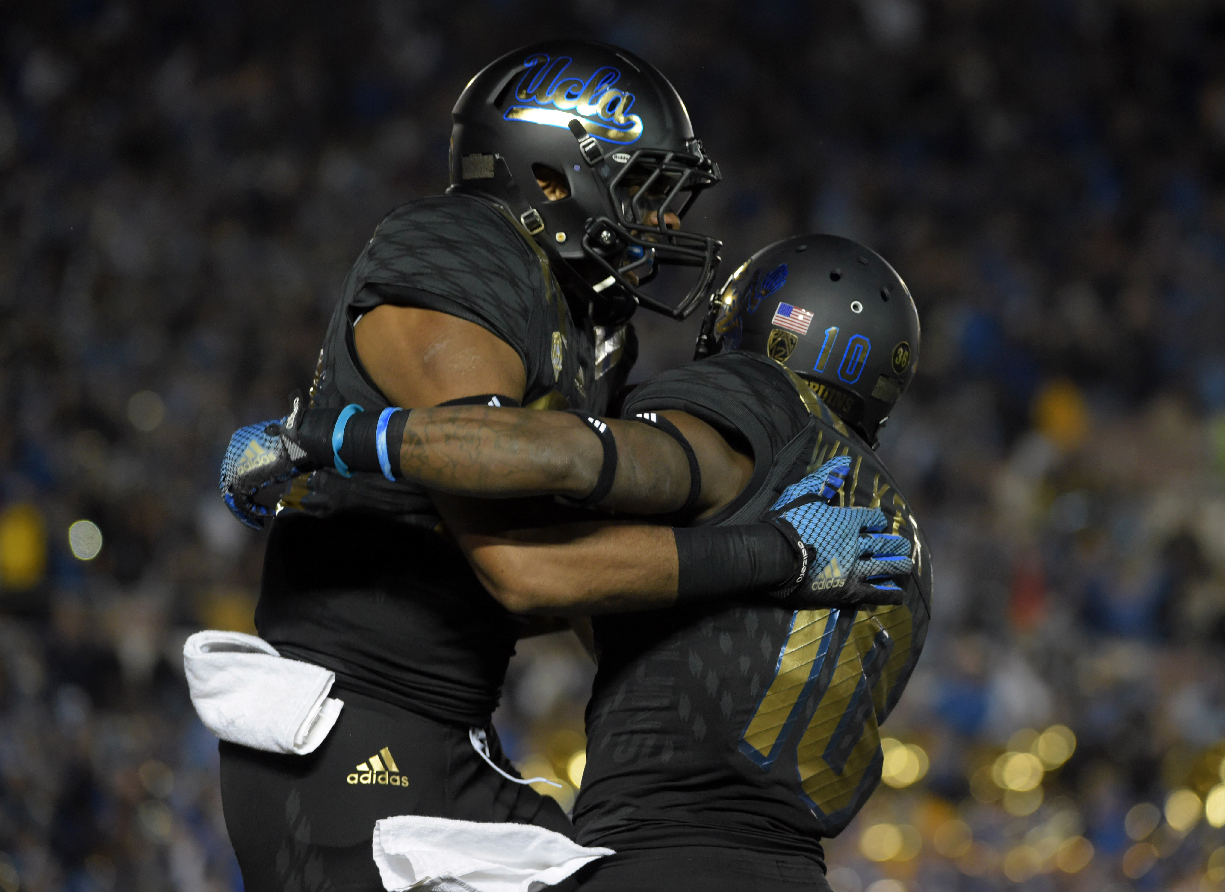 Nov 14, 2015; Pasadena, CA, USA; UCLA Bruins running back Nate Starks (23) celebrates with receiver Kenneth Walker III (10) after scoring on a 14-yard touchdown run in the second quarter against the Washington State Cougars in a NCAA football game at Rose Bowl. (Kirby Lee/USA TODAY Sports)