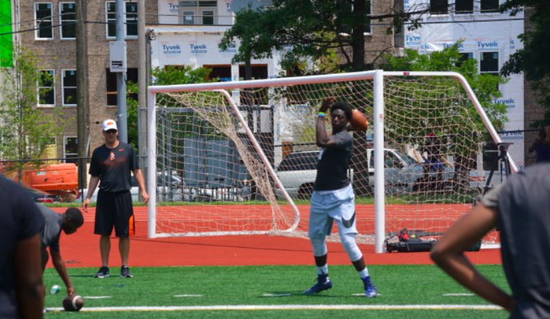 Mike Yurcich looks on as Jelani Woods throws a pass. at satellite camp. [Credit: Rivals]