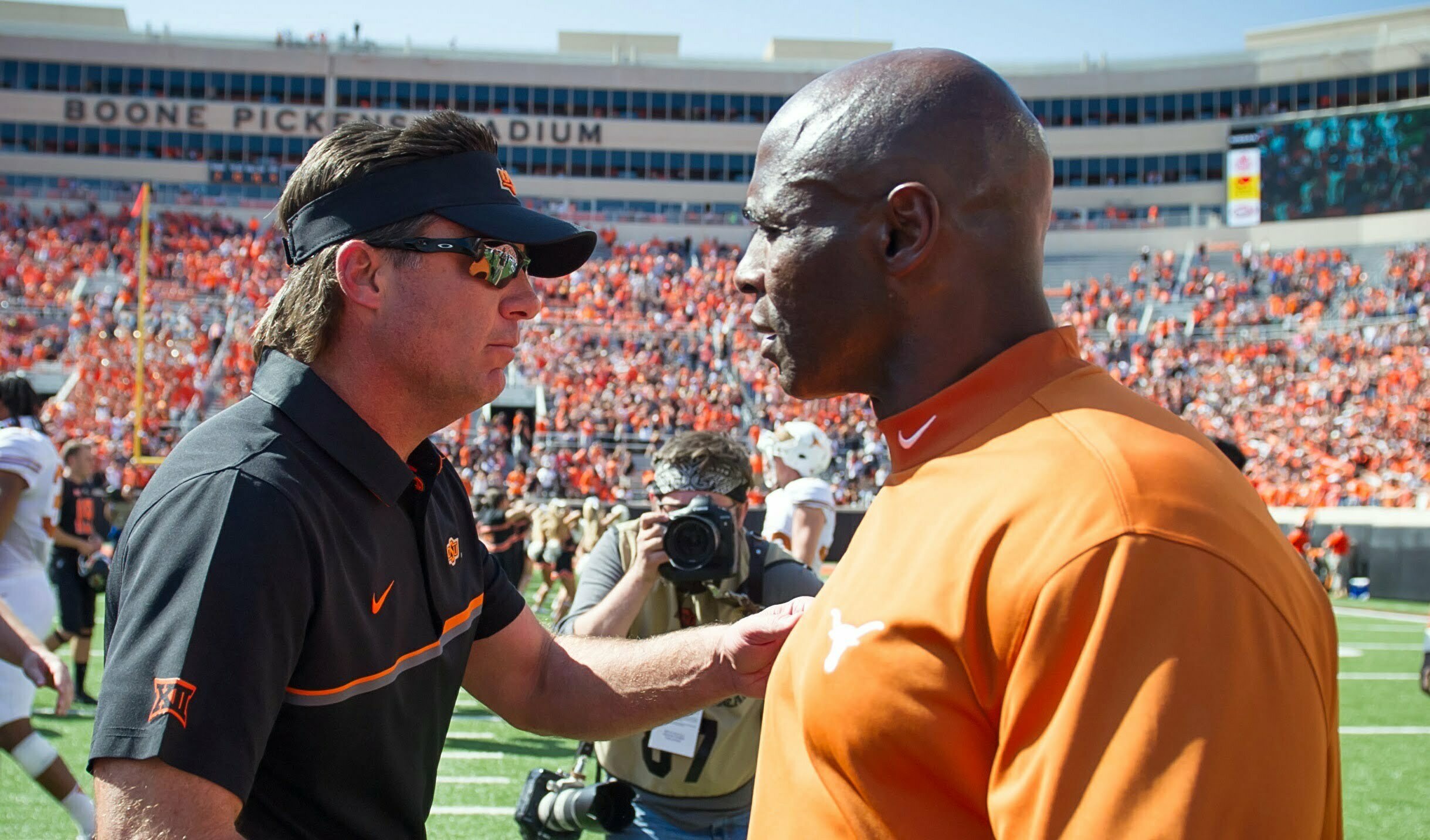 Oct 1, 2016; Stillwater, OK, USA; Oklahoma State Cowboys head coach Mike Gundy and Texas Longhorns head coach Charlie Strong shake hands after the game at Boone Pickens Stadium. Mandatory Credit: Rob Ferguson-USA TODAY Sports